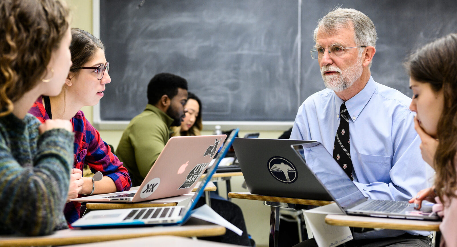 Professor participates in a group discussion while teaching an honors seminar.