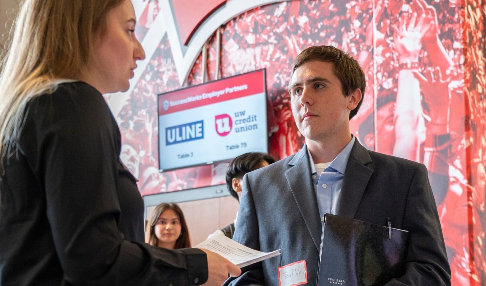 UW–Madison student talks with a representative from Colony Brands as students attend the All-Campus Career and Internship Fair at the Kohl Center at the University of Wisconsin–Madison.