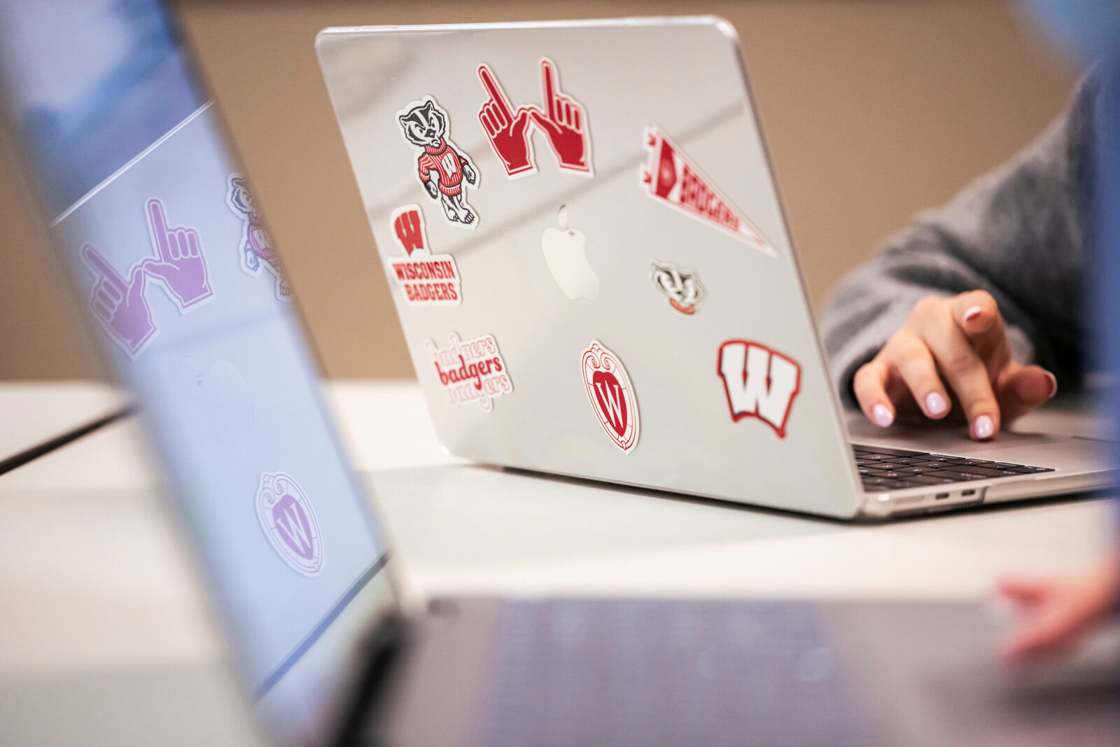 Bucky Badger and other Wisconsin-themed stickers are pictured covering a student’s laptop