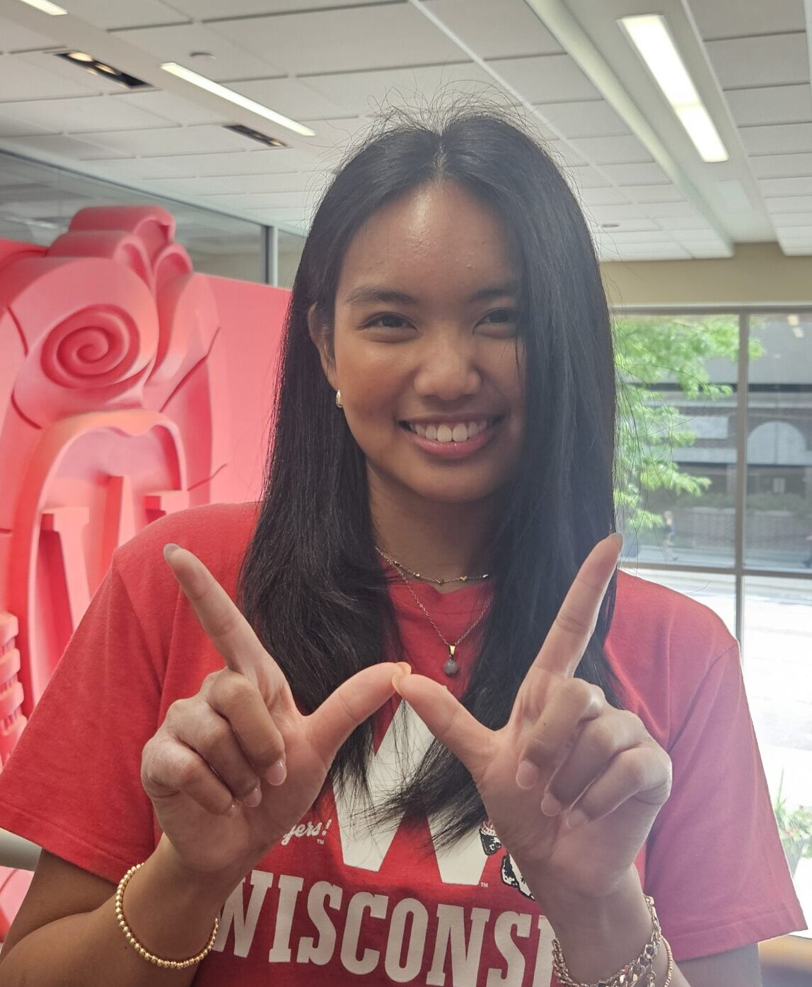 Photo of Eliana Reyes holding up "W hands"